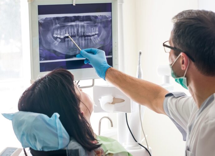 doctor-dentist-showing-patients-teeth-on-xray-picture