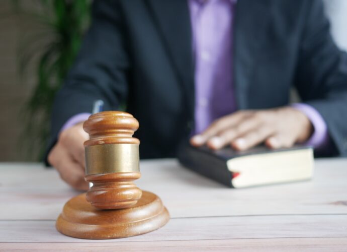 The Picture shows a man holding a gavel legal translation dubai